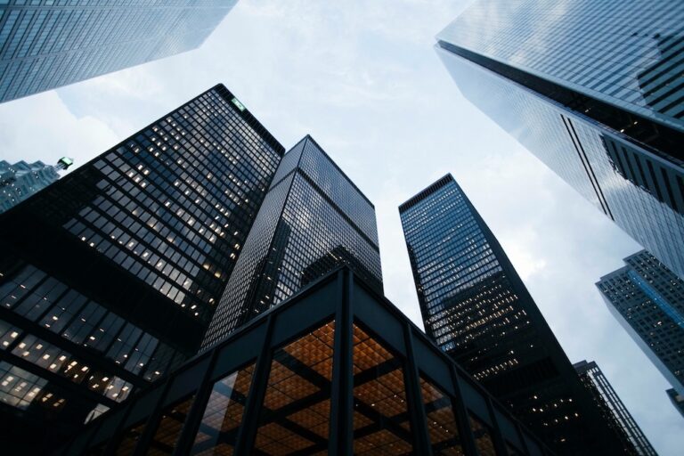 Looking up at glass commercial office towers in a Canadian city financial district, representing commercial lease disputes in BC.